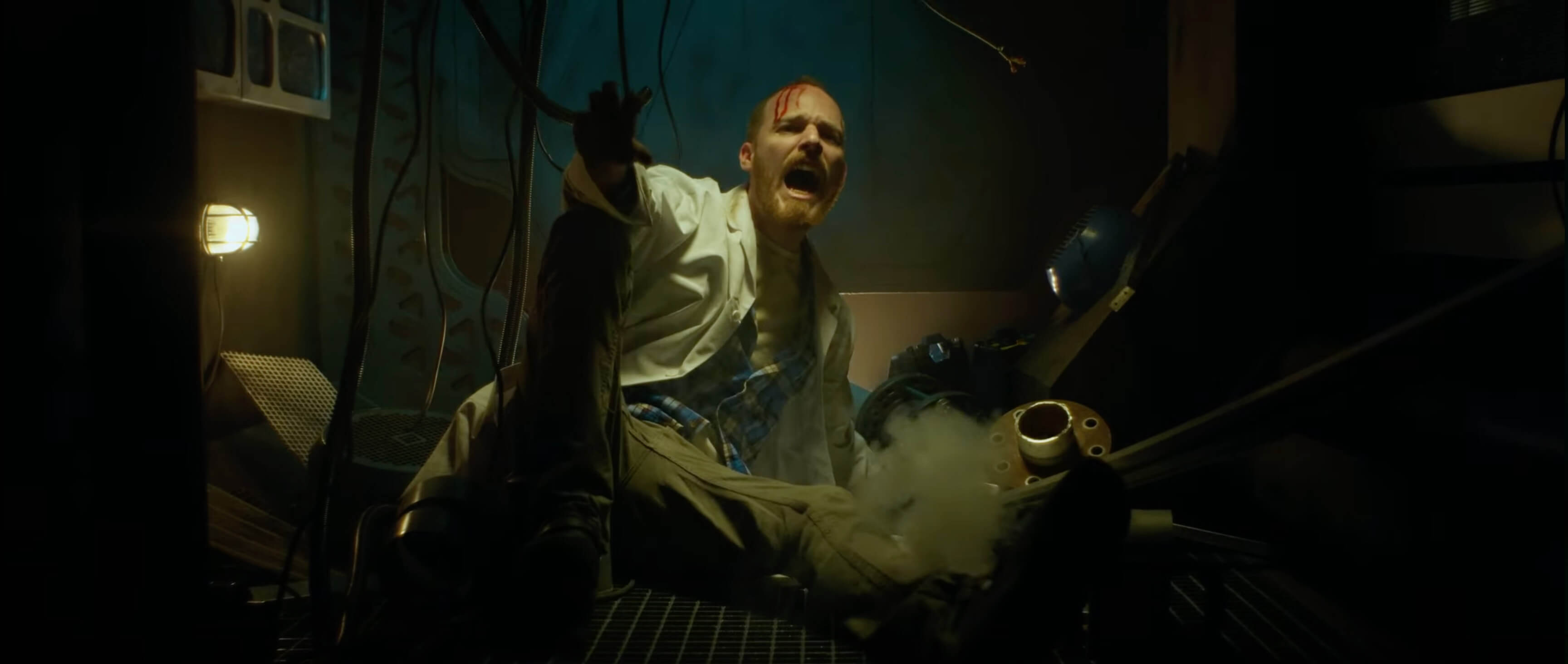 Scene from the trailer of an escape room called Aliens in Bilbao, Spain, showing a doctor lying on the floor and screaming