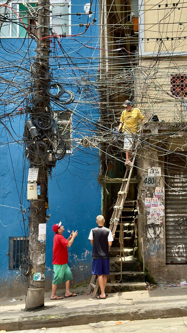Picture of the largest fabela in Brazil, Rocinha - Rio de Janeiro, some men trying to fix a lamp post